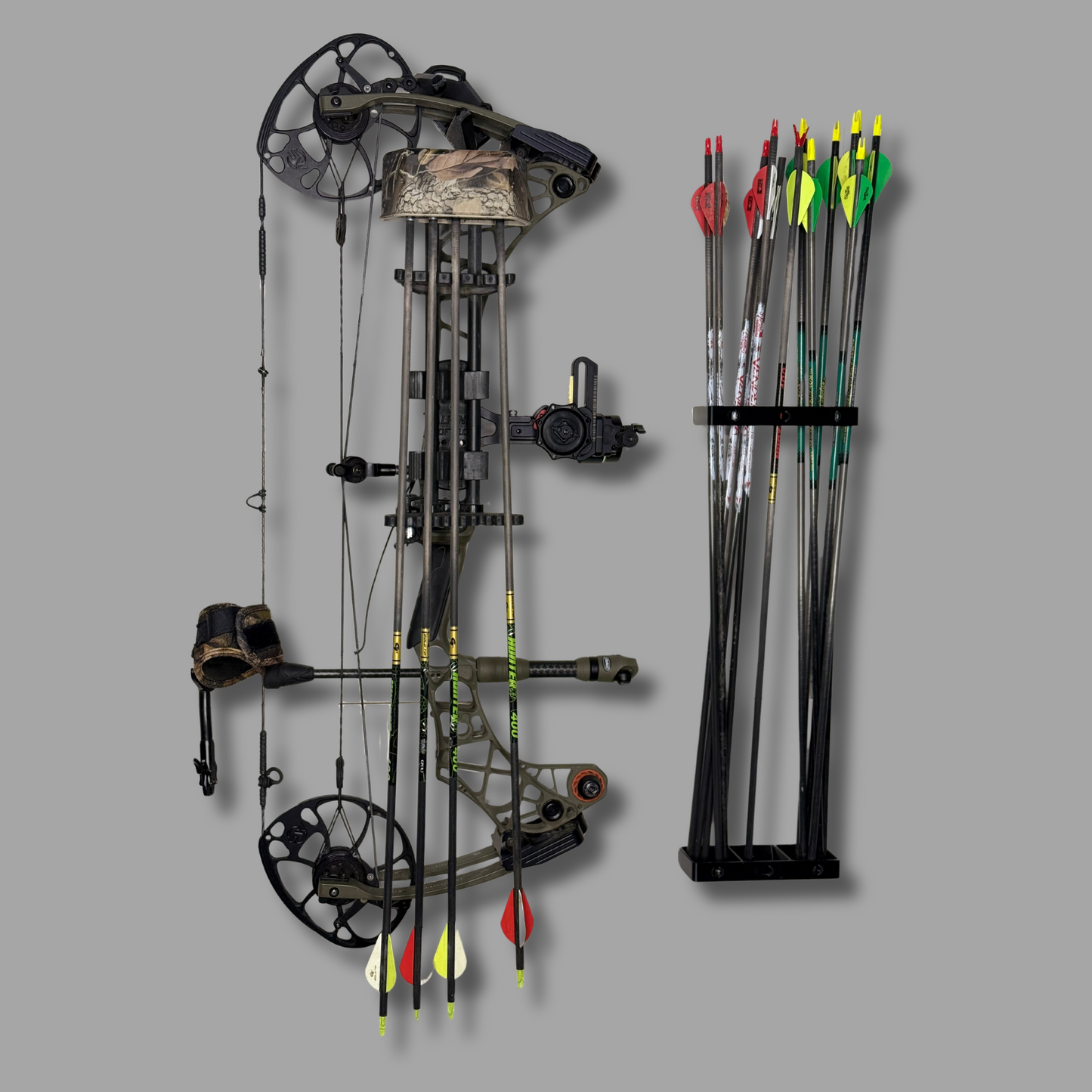 Compound bow and arrows displayed on wall with WAYMKR mounts