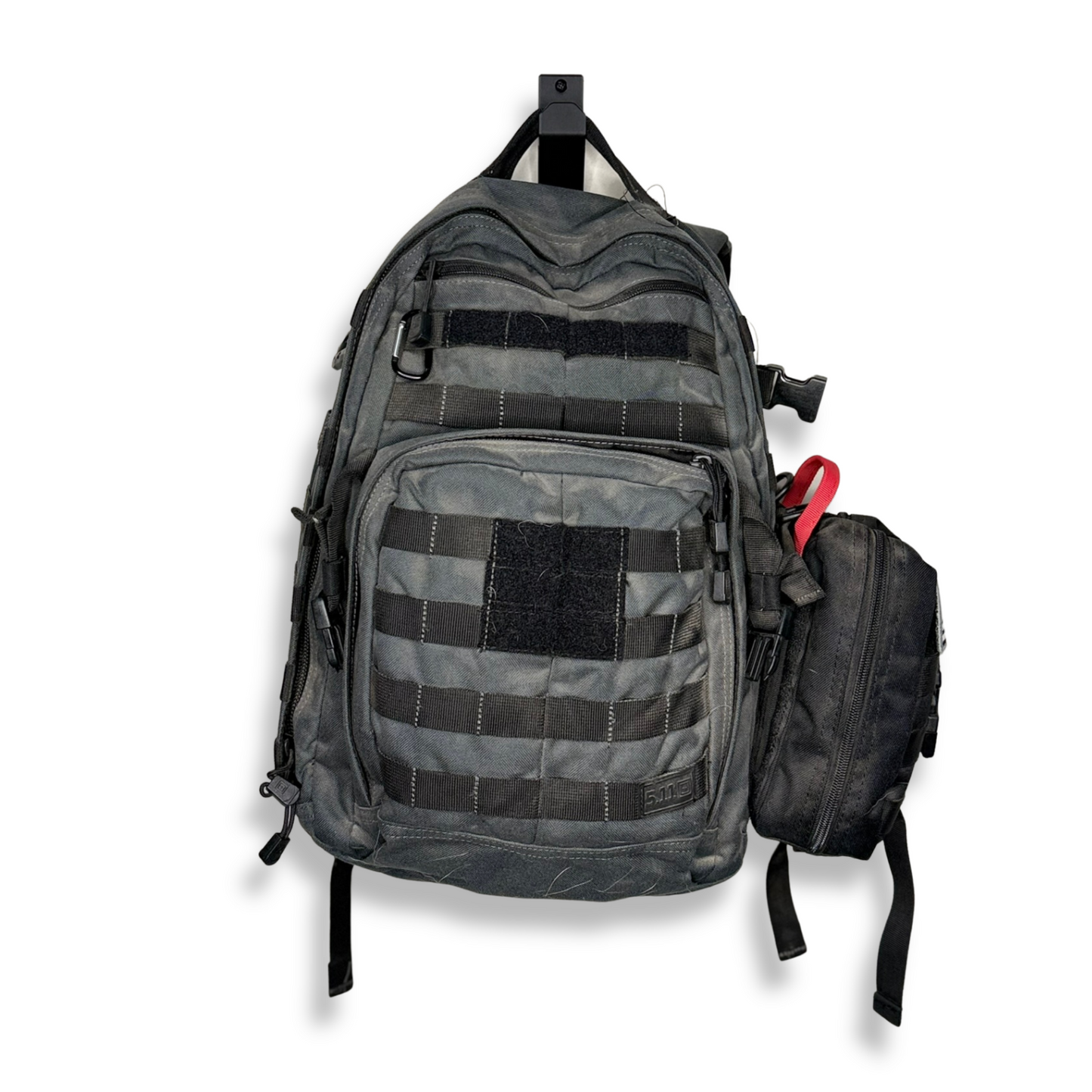 Gray tactical backpack with multiple compartments on waymkr go bag mount