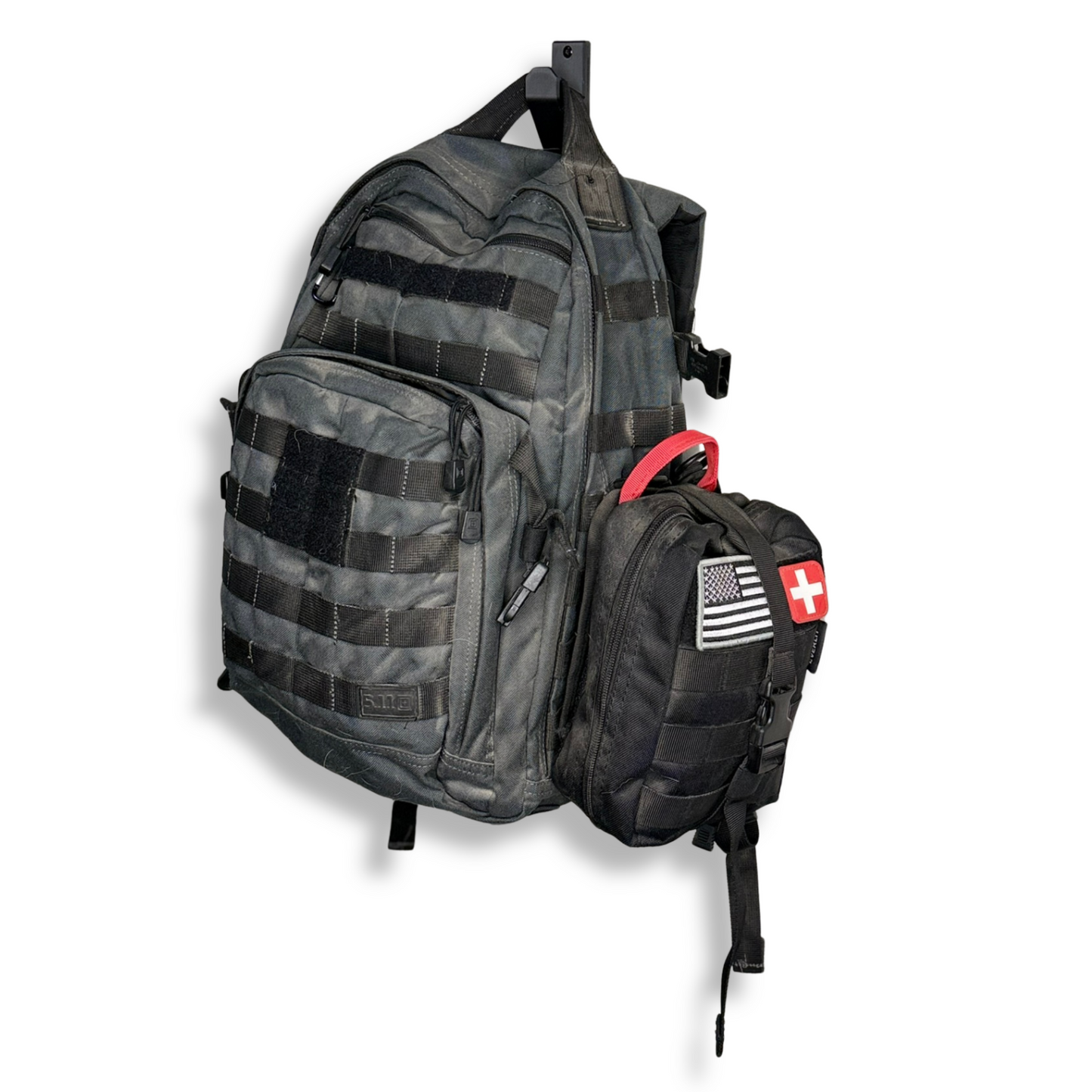 Gray tactical backpack with multiple compartments on waymkr go bag mount